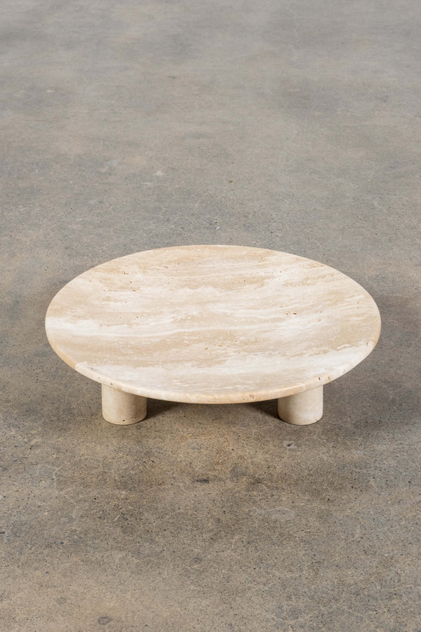 Round Footed Plate in Travertine, front angled view